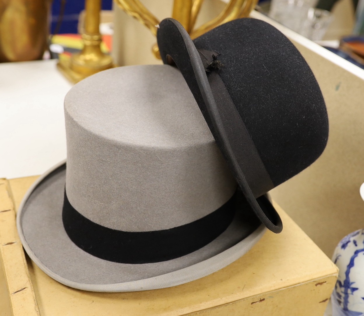 An Austin Reed boxed grey top hat together with a black bowler hat